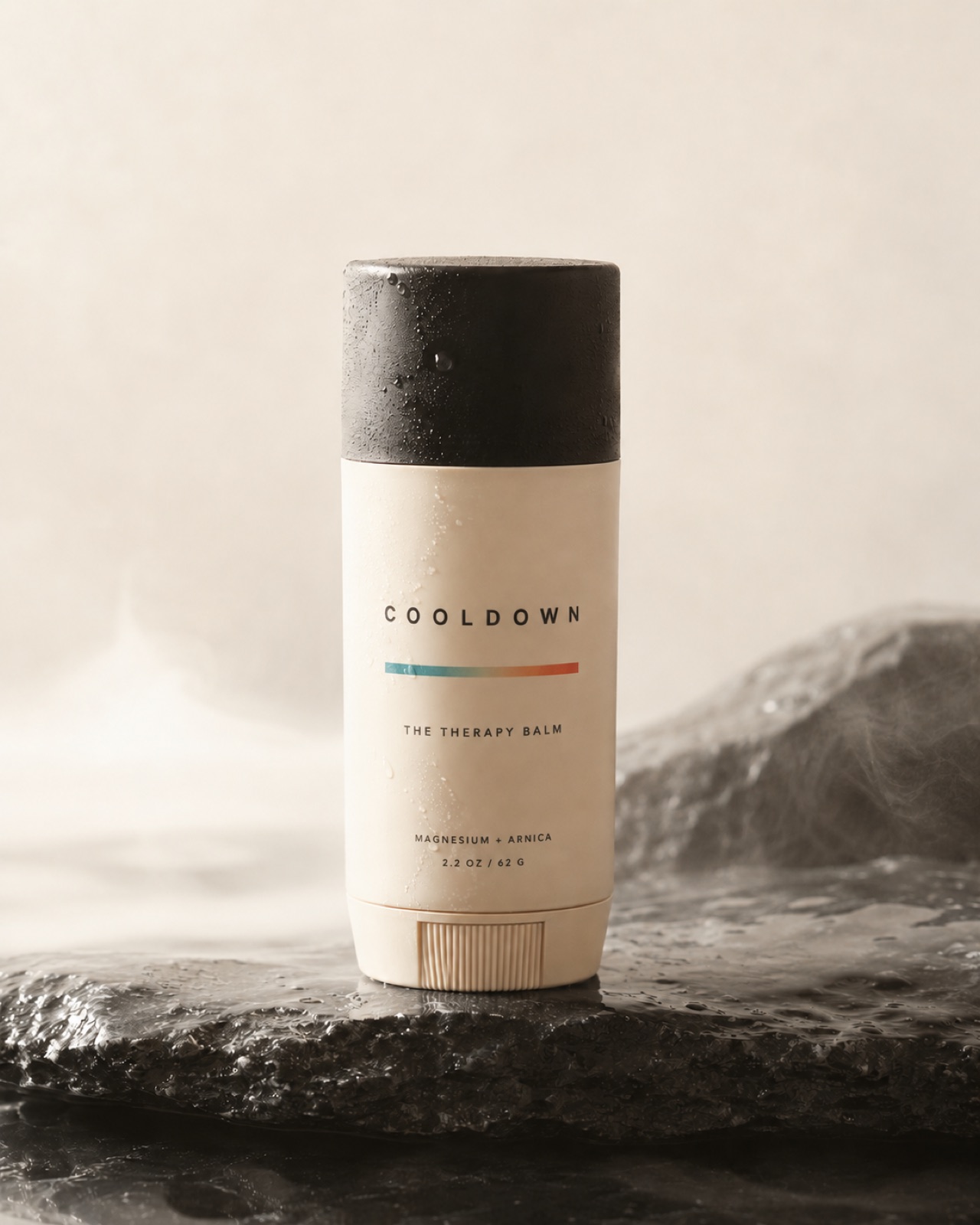 The Therapy Balm — Cooldown recovery stick on wet slate stone